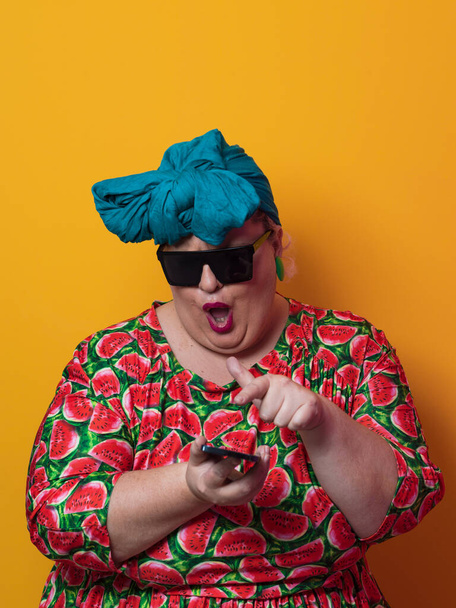 Blonde plus size woman having conversation talking by smartphone over yellow background smiling with an idea or question pointing finger with happy face, number one - Foto, immagini