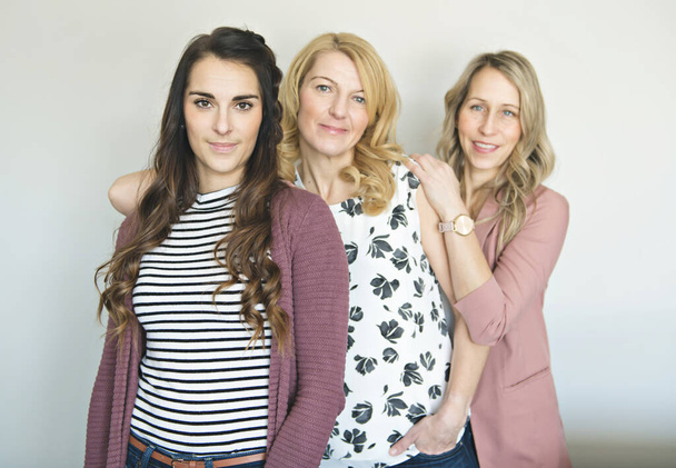 Group of friends woman portrait close to a white wall - Fotoğraf, Görsel