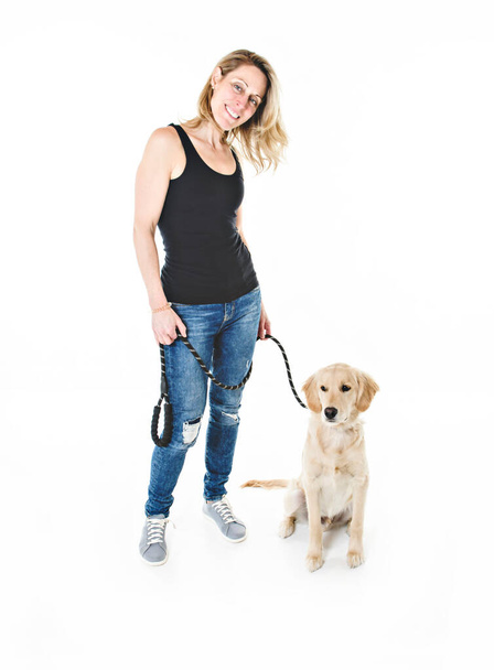 Nice woman and her beautiful Golden Retriever dog over white background - Фото, зображення