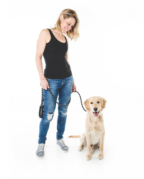 Nice woman and her beautiful Golden Retriever dog over white background - Foto, afbeelding