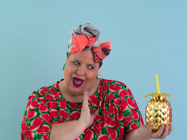 Overweight plus size female, fat women, Fat girl, Chubby, holding golden fruit ananas isolated on cyan background - lifestyle Woman diet weight loss overweight problem concept.  - Zdjęcie, obraz
