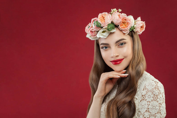 Retrato de una joven morena con flores. Cara de mujer con maquillaje y peinado - Foto, Imagen