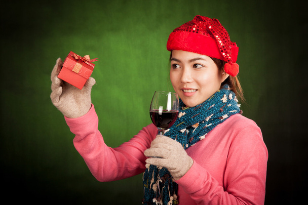 Asian girl with christmas hat ,wine and gift box - 写真・画像
