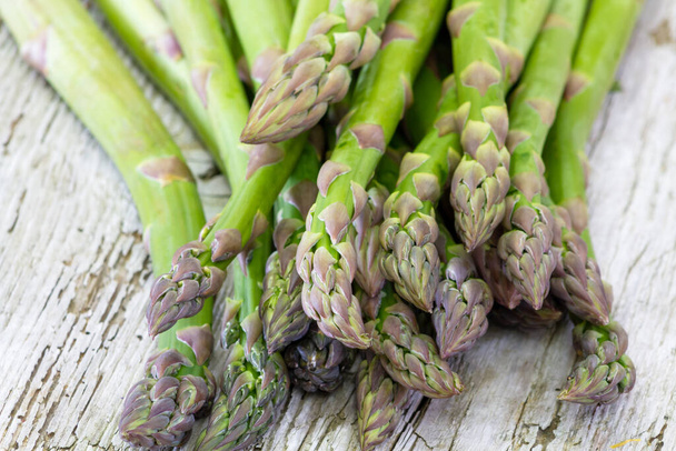 fresh green asparagus on a wooden background - Valokuva, kuva