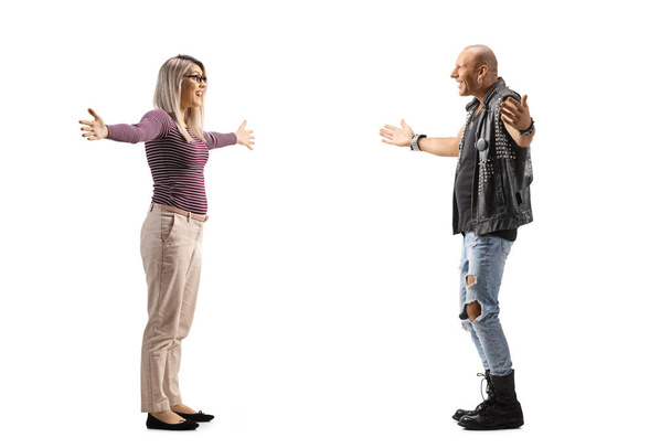 Full length profile shot of a young woman meeting a bald man with arms wide open isolated on white background - Foto, immagini