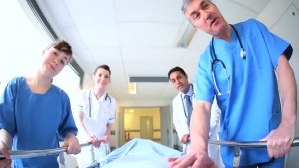 Nursing staff escorting patient in bed - Footage, Video