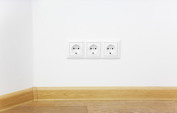 Empty interior white wall with power outlet / wooden floor - Foto, Bild