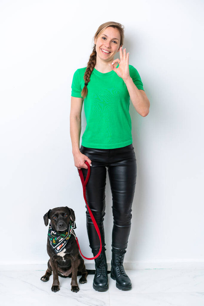 Full body of girl with her puppy isolated on white background showing ok sign with fingers - 写真・画像