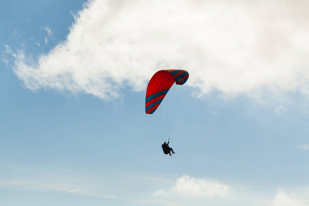 Paraglider flying over clouds in summer day - Photo, Image