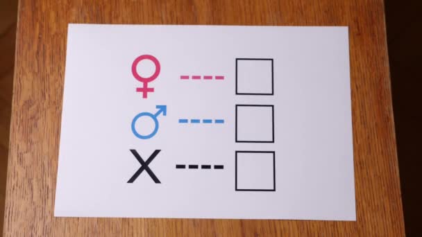 A person is determined by his gender. Sheet of paper with gender symbols. The right to one's identity. - Séquence, vidéo