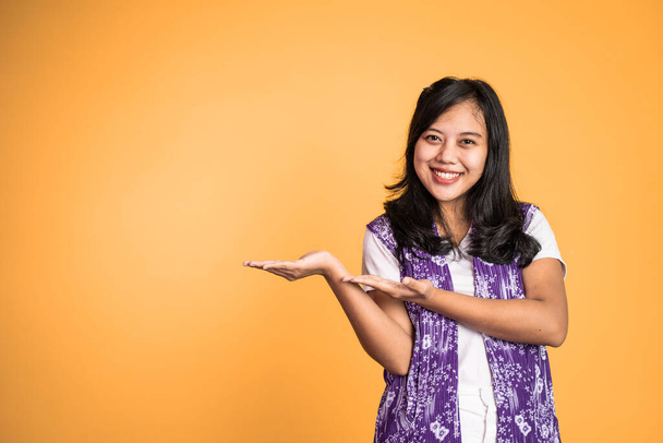 Asian girl with hand gesture presenting something on isolated - Photo, image