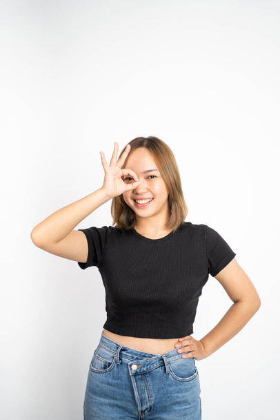 woman showing oke gesture with hands near eye looks imitating binocular - Fotografie, Obrázek