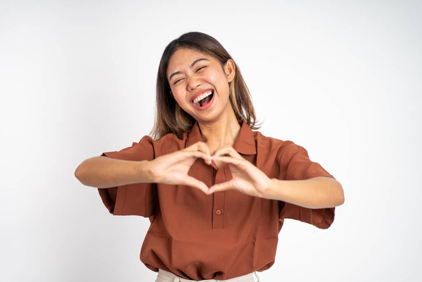 woman smiling in heart shape with fingers on isolated - Фото, изображение