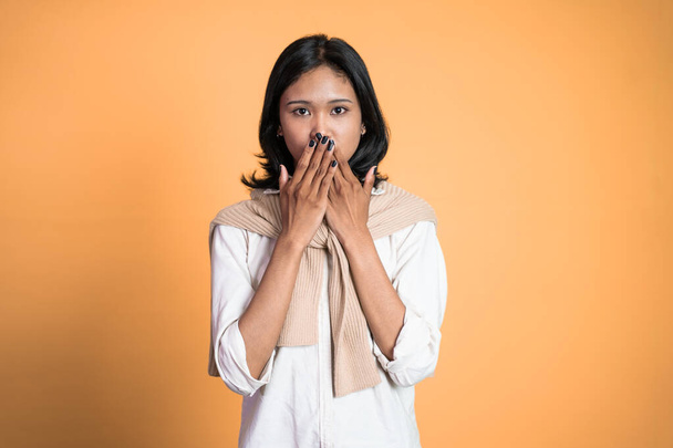 portrait of asian woman covering her mouth with hands - Photo, image