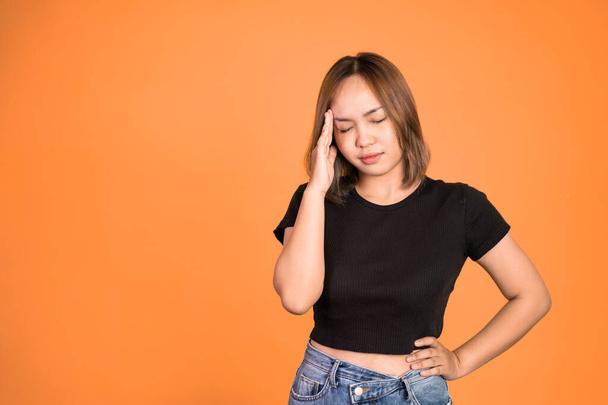 frustrated Asian young woman holding head with headache - Photo, image