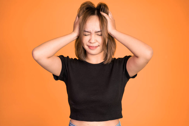 frustrated Asian young woman holding head with headache - Foto, Imagem