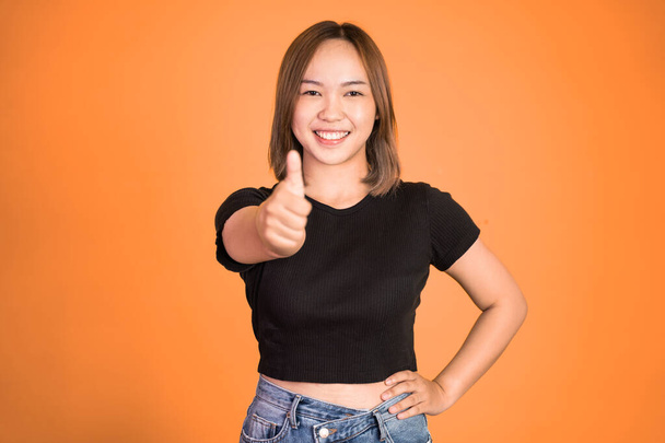 woman stand with thumbs up on isolated background - Фото, изображение