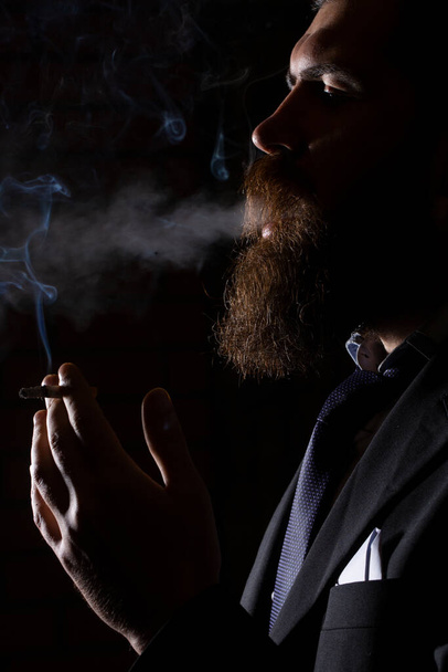 Man smoking cigarette isolated on black studio. - Φωτογραφία, εικόνα