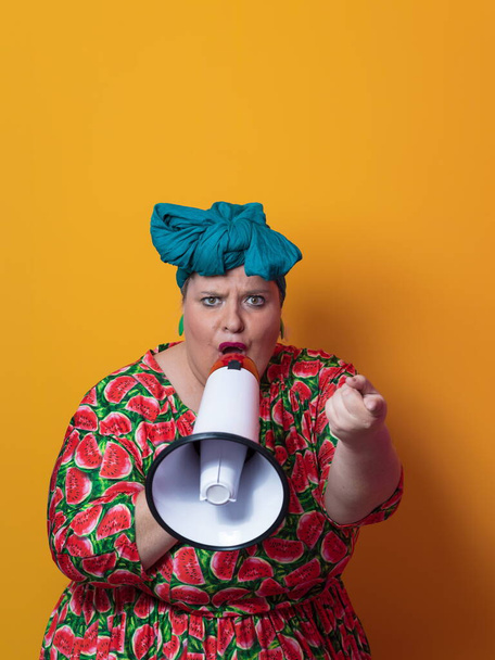 Funny plus size woman posing isolated on yellow background studio portrait. Overweight lady screaming in a megaphone. People emotions lifestyle concept. Mock up copy space. - Fotoğraf, Görsel