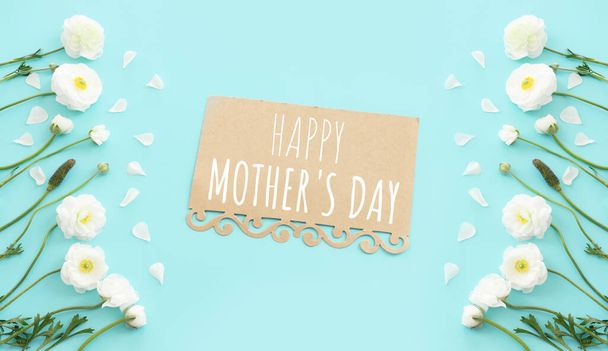 mother's day concept with white flowers over blue pastel background - Foto, Imagen