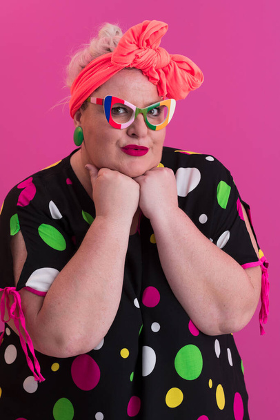 Happy Plus Size Woman Wearing Eyeglasses Smiling To Camera Standing Over Pink Background. Cheerful Millennial Female In Eyewear Posing In Studio. - Photo, Image