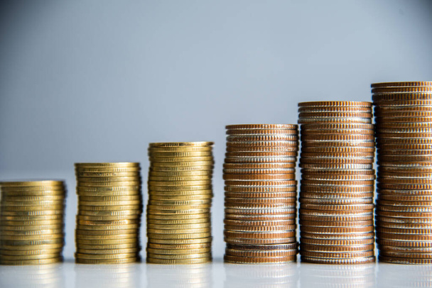 Coins stacking on gray background in saving money concept. - Φωτογραφία, εικόνα