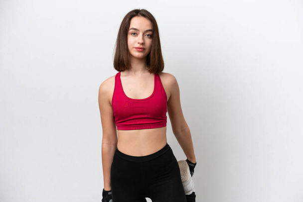 Photo of posing athletic female. Smiling woman with fit, curvy body doing  sport exercises. Model having slim, stunning figure, wearing sport trousers  and top, also sneackers for professional run. Stock-bilde