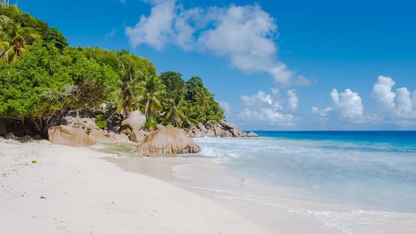 Anse Patates beach, La Digue Island, Seyshelles, white beach with blue ocean and palm trees - Photo, Image