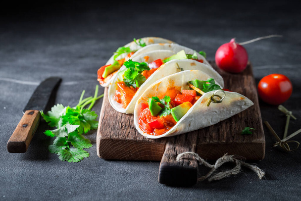 Tasty and vegetarian tacos with tomatoes, radish and coriander. Spicy Vegetarian Tacos with Vegetables. - Foto, imagen
