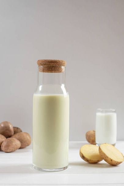 potato milk bottle on a light background - Φωτογραφία, εικόνα