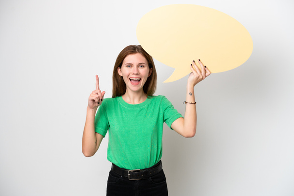 Young English woman isolated on white background holding an empty speech bubble with surprised expression - Zdjęcie, obraz