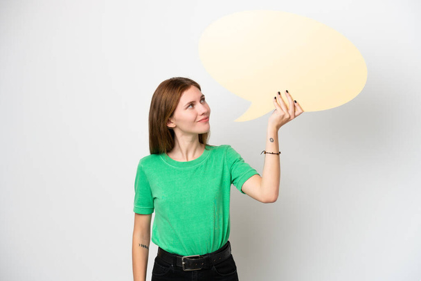 Young English woman isolated on white background holding an empty speech bubble - Photo, Image