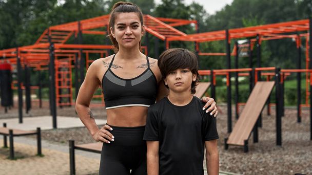 Caucasian athletic mother and son on sports ground - Foto, Imagen