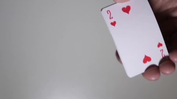 Actions of a man when he shuffles a deck of cards. The croupier shuffles a deck of cards in a game of poker. - Video, Çekim
