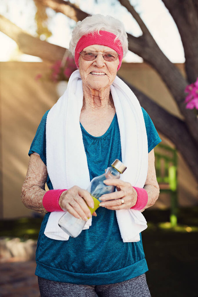 Vieillir est inévitable, se mettre en forme est un choix. Prise de vue d'une femme âgée faisant de l'exercice à la maison. - Photo, image