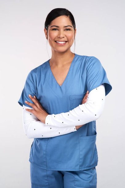 Doctors- There are roads left in both of our shoes. Portrait of a beautiful young doctor standing with arms folded against a white background. - Fotoğraf, Görsel