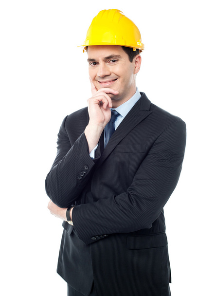 Businessman holds his hand on his chin - Фото, зображення