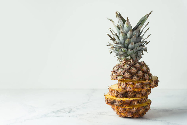 ripe pineapple cut into pieces on a white background. Close up. Juicy fruit - Foto, Imagen