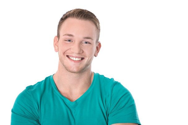 Happy isolated young blond man in green shirt smiling: white tee - Valokuva, kuva