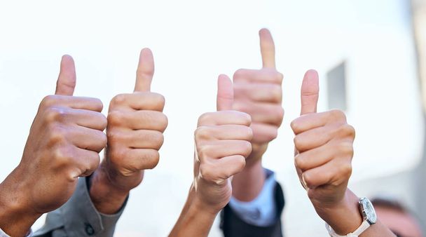 Great work, team. Shot of a group of unrecognizable businesspeople showing a thumbs up. - Photo, Image