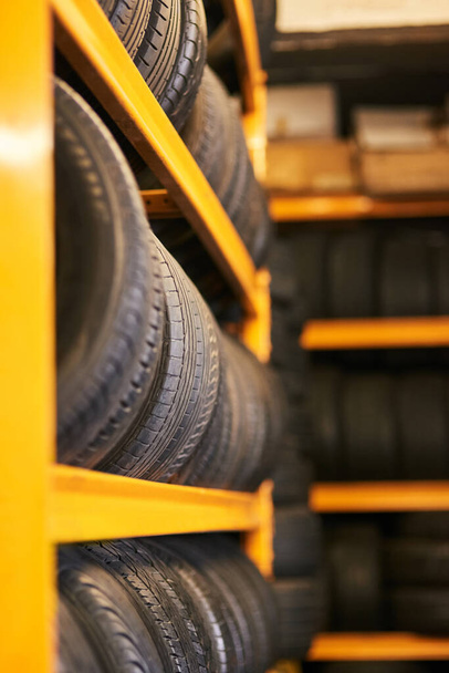 Workshop full of wheels. Closeup shot of a pile of car tyres. - Photo, Image