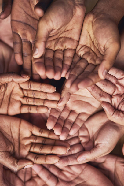 Seeking your help. Shot of a group of hands held cupped out together. - Fotó, kép