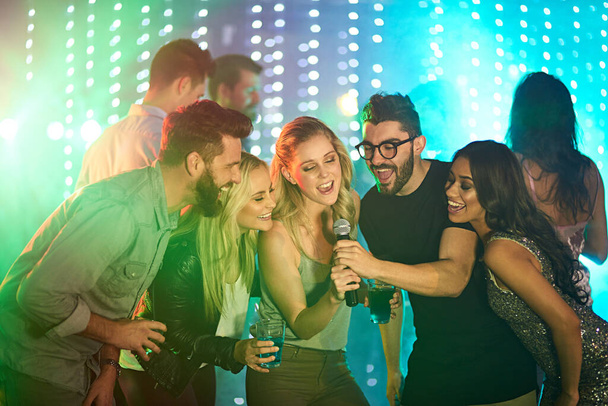 Theres a superstar in all of us. Shot of a group of friends singing karaoke at a party. - Fotó, kép