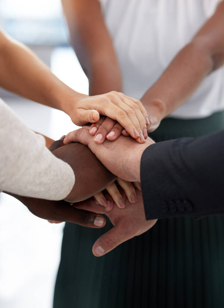 Success is what we all strive for. Closeup shot of a group of unrecognisable businesspeople joining their hands together in a huddle. - Foto, Imagem