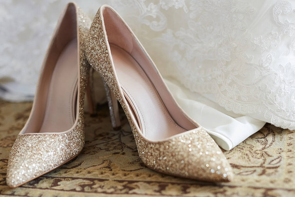 Short in height, big on style. Closeup shot of a brides wedding shoes. - Фото, изображение