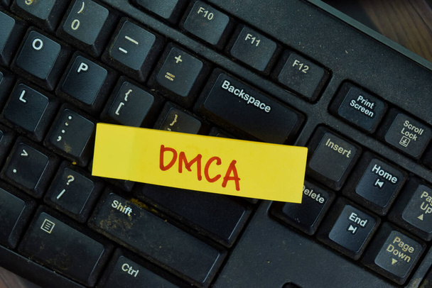 DMCA write on sticky notes isolated on Wooden Table. - Fotó, kép