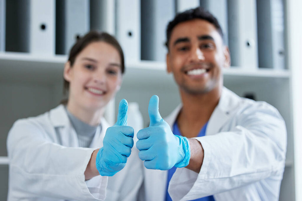 Our research will make a big difference. Closeup shot of two scientists showing thumbs up in a lab. - Fotoğraf, Görsel