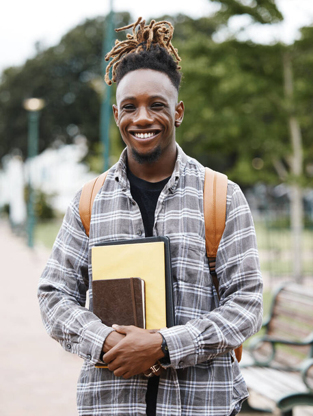 Hard work pays off. Shot of a young man holding books on campus. - Foto, immagini