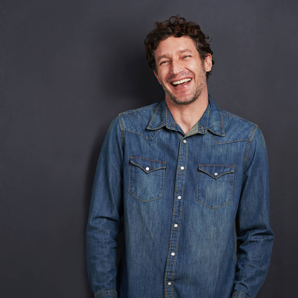 I need approximately 5 laughs per day to survive. Studio portrait of a handsome man laughing while standing on a gray background. - Foto, Imagem