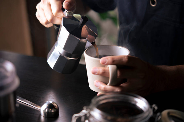 Moka pot pouring coffee. - Fotografie, Obrázek